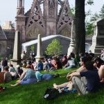 memorial day concertgoers near main entrance arch