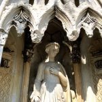 carved stone woman in green-wood cemetery monument