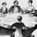 black and white image of everyone touching a tabletop