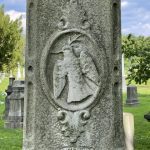 carved bird on grave monument